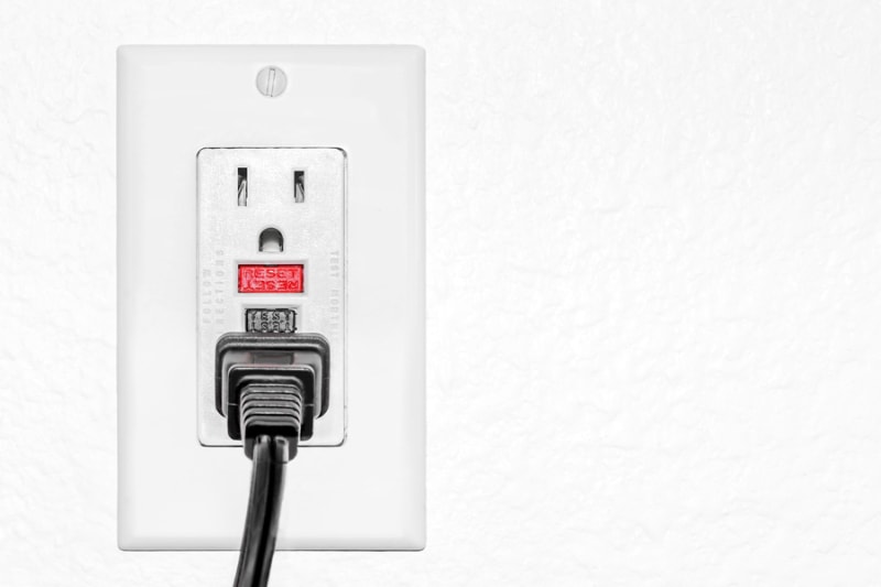What Is a GFCI? Ground fault circuit interrupter red reset and black test button to prevent electric shock.