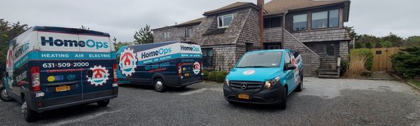 Home Ops service vans parked in front of home.